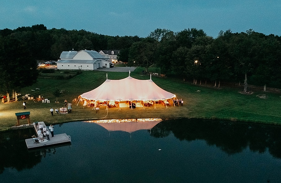 tented wedding reception at night at the Barn at Glistening Pond
